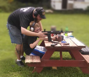 Gary teaches son, Rylie, how to shoot