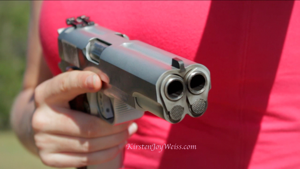 holding double barrel close up gun words